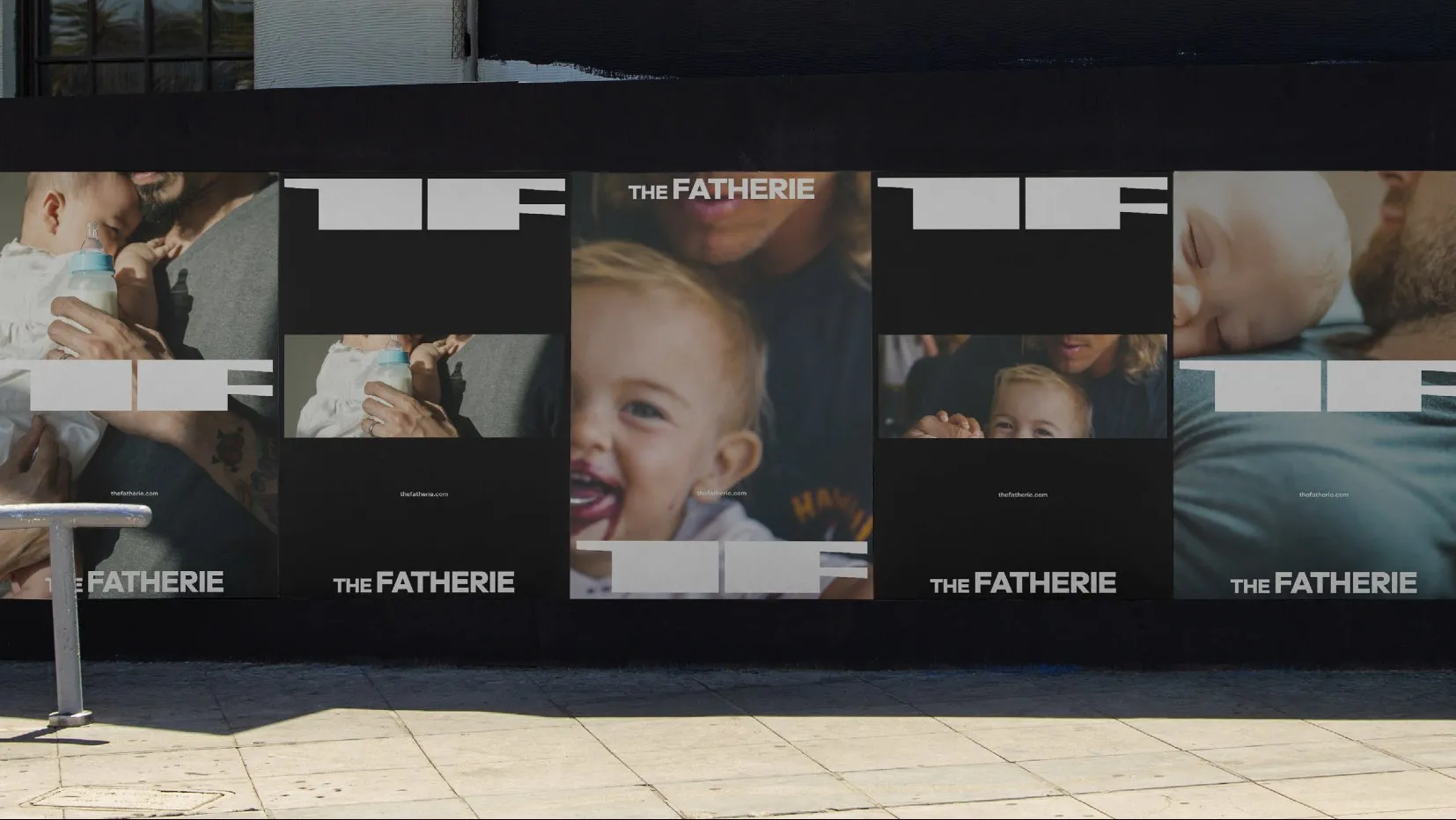 A street hoarding papered with The Fatherie posters, photographs of dads and babies under the wordmark