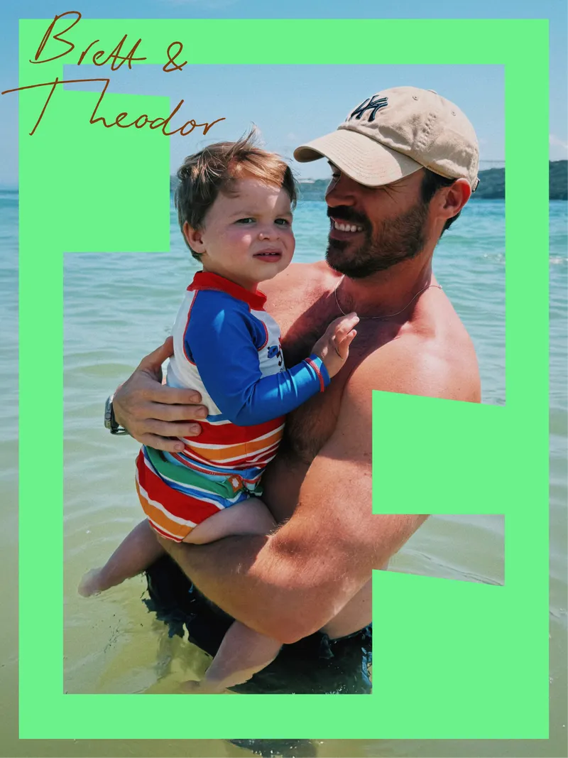 Snapshot of a father holding his son at the beach, captioned “Brett & Theodor”